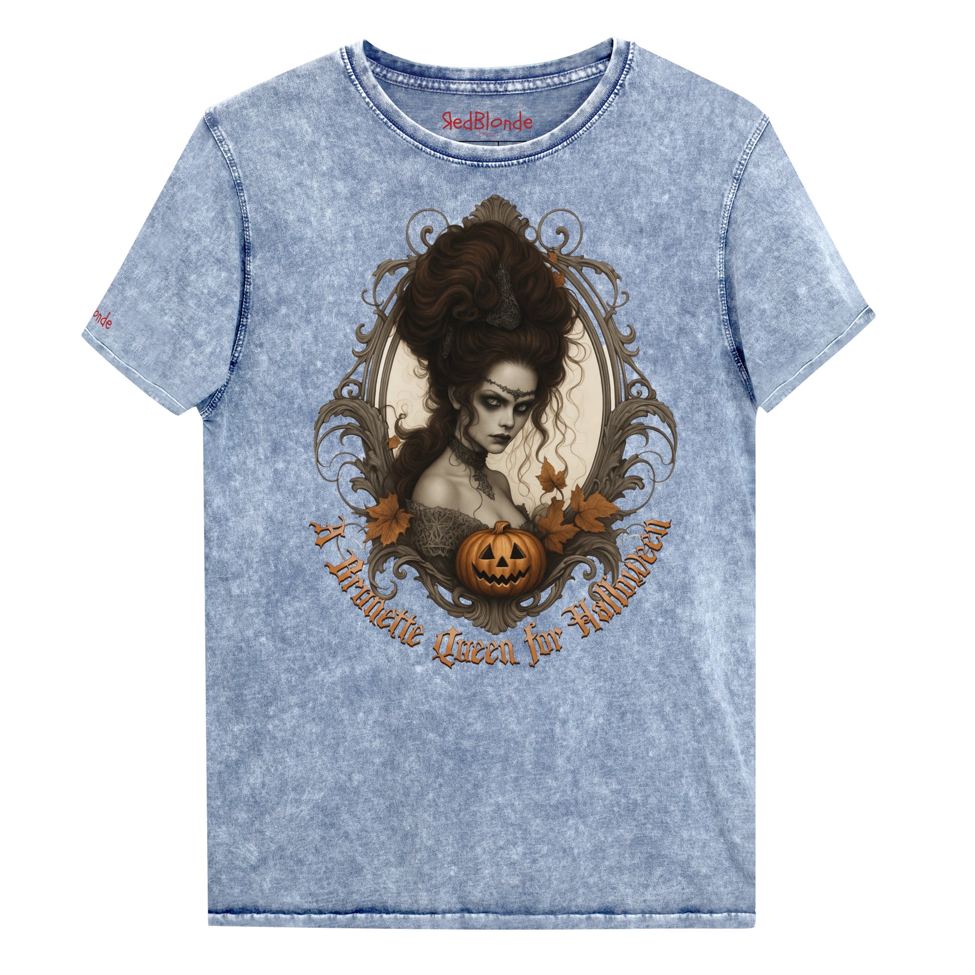 blue acid-wash unisex T-shirt featuring a gothic-style illustration of a dark-haired woman with an elaborate beehive hairstyle, framed by ornate scrollwork, autumn leaves, and a carved pumpkin. The design is captioned with the text ‘A Brunette Queen for Halloween’ in vintage Dark Angle lettering. Branded RedBlonde in red on inside neck and right sleeve