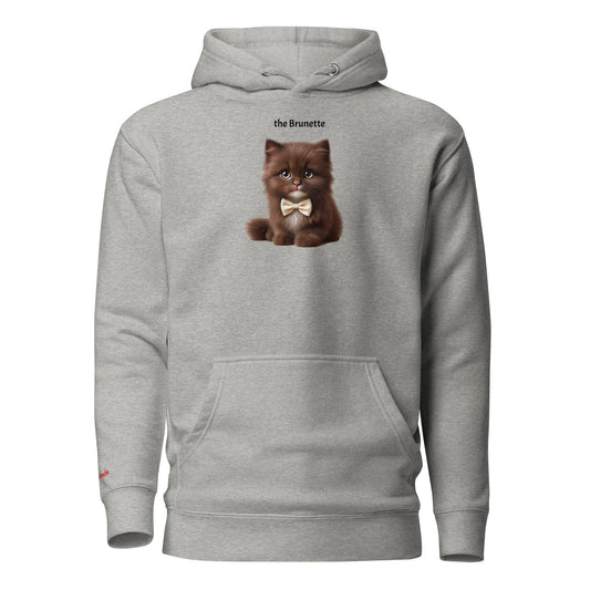 Flatlay of carbon grey relaxed fit unisex hoodie with a cute graphic of a brunette kitten wearing a bow-tie and the words 'the Brunette' linking to Brunette hair. Branded RedBlonde in red on inside neck and right cuff
