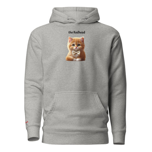 Flatlay of carbon grey relaxed fit unisex hoodie with a cute graphic of a redhead kitten wearing a bow-tie and the words 'the Redhead' linking to Red hair. Branded RedBlonde in red on inside neck and right cuff