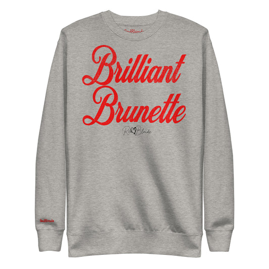 A classic grey relaxed fit unisex sweatshirt with the words 'Brilliant Brunette' written in large red vintage milkstore font, like coco cola script. Branded RedBlonde London in red on inside neck and right sleeve 