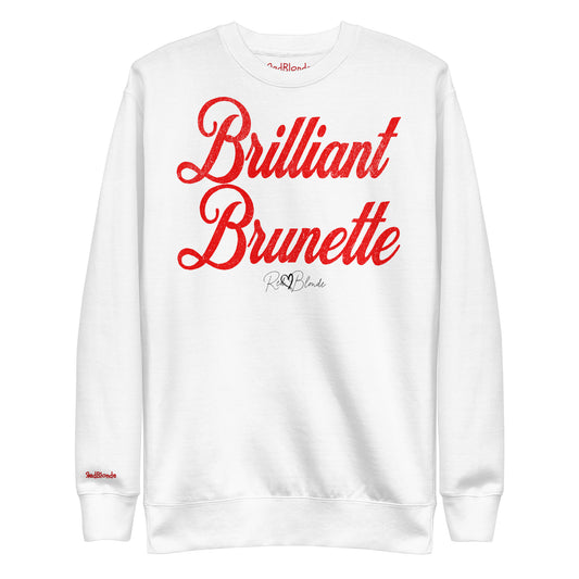A classic white relaxed fit unisex sweatshirt with the words 'Brilliant Brunette' written in large red vintage milkstore font, like coco cola script. Branded RedBlonde London in red on inside neck and right sleeve 