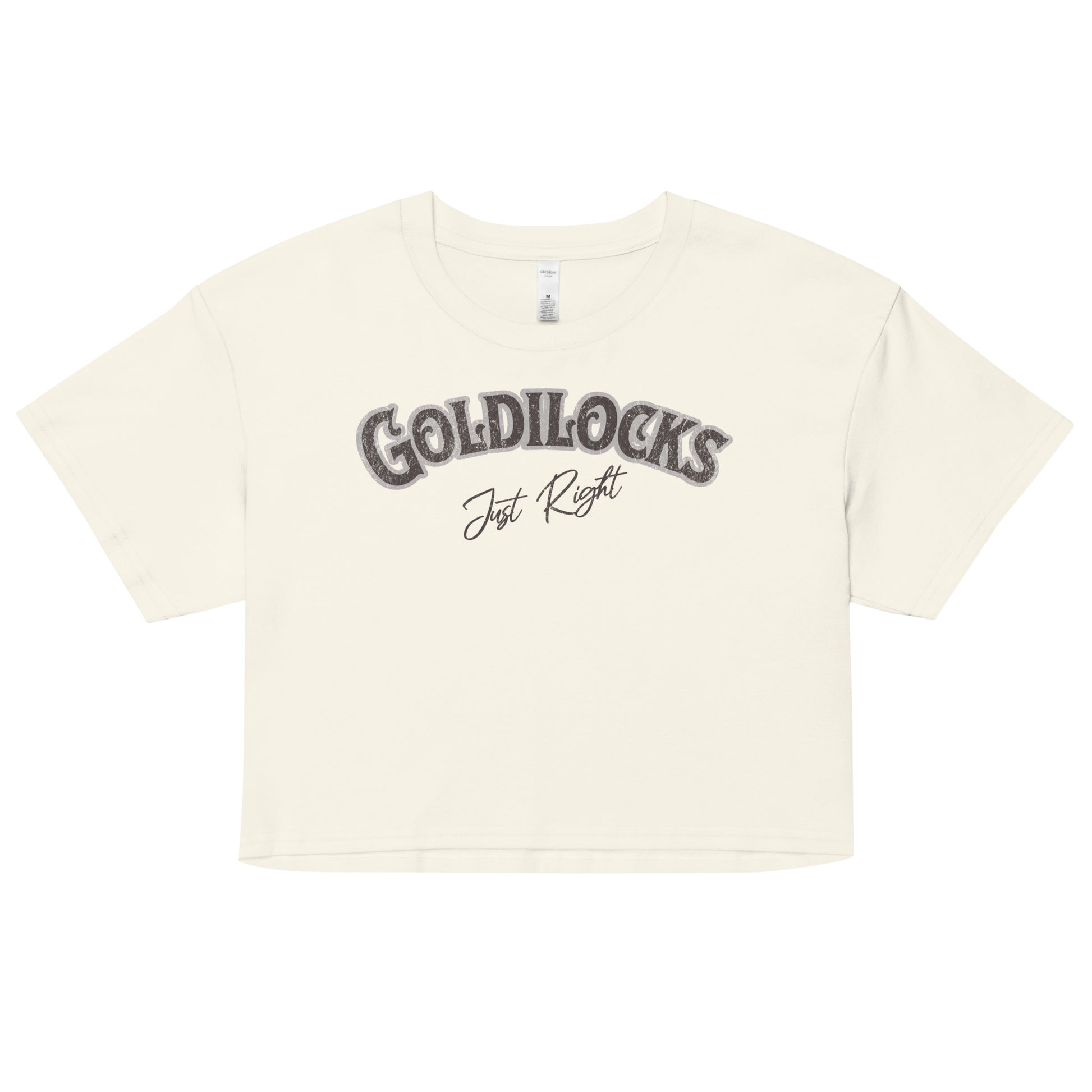 cream women’s crop top with the text “Goldilocks Just Right” in black and white Signmaster Pro textured font, designed in a bold retro style. Branded RedBlonde on the reverse