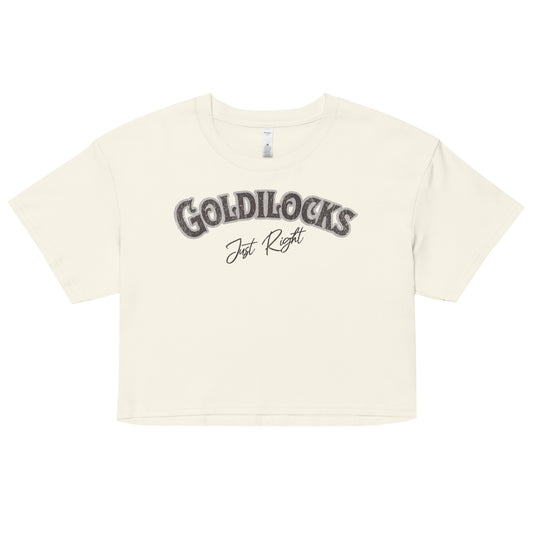 cream women’s crop top with the text “Goldilocks Just Right” in black and white Signmaster Pro textured font, designed in a bold retro style. Branded RedBlonde on the reverse