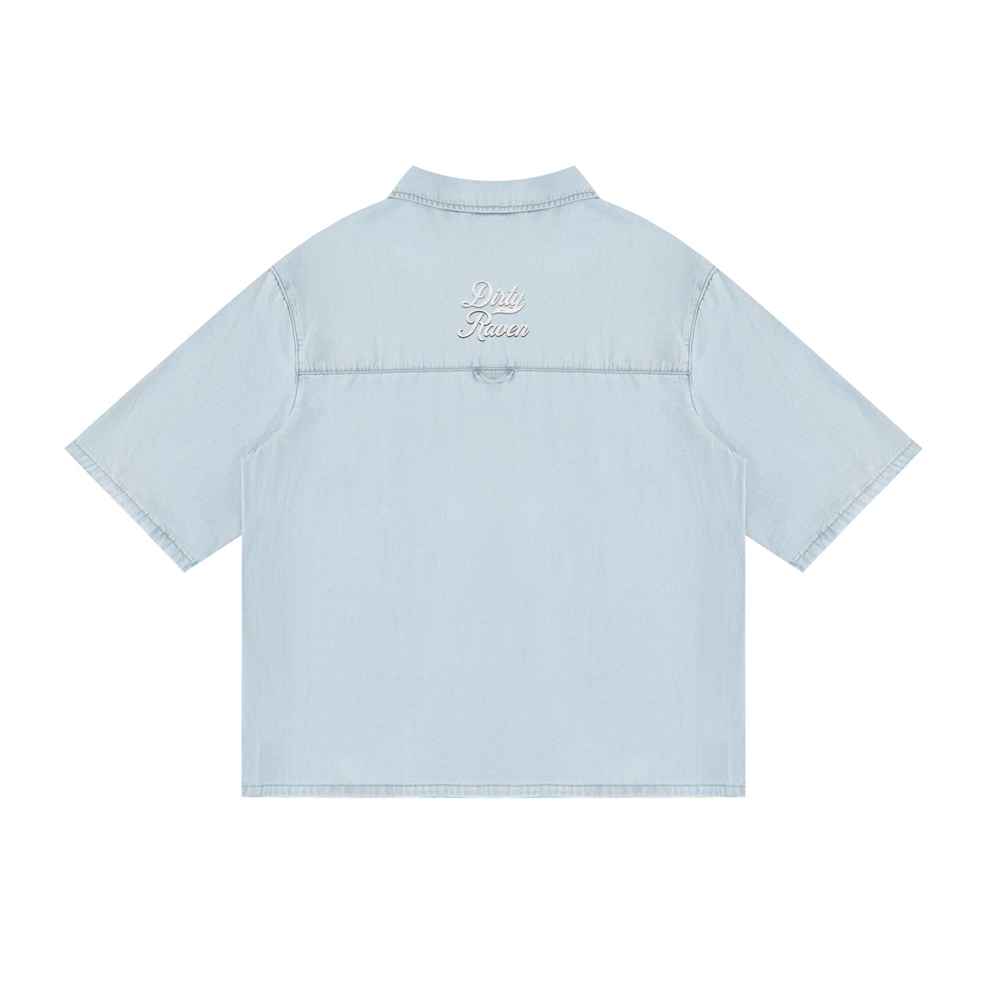 back view of a light blue, short-sleeve button-up shirt with a subtle faded finish and a small raised “Dirty Raven” Milkstore script logo centered across the upper back.