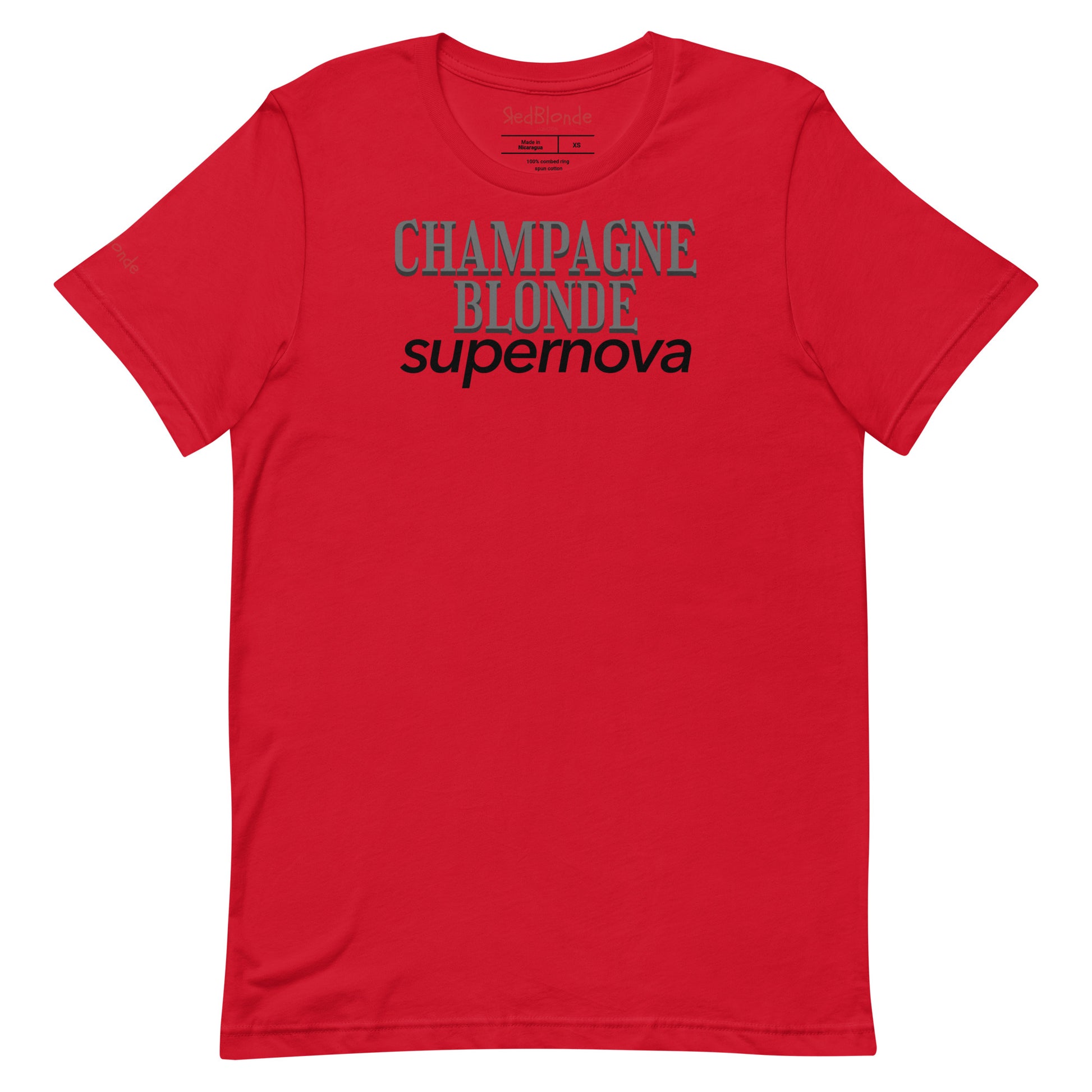 flatlay of red unisex t-shirt with the words 'CHAMPAGNE BLONDE' in grey Girasoll font with 'supernova' underneath  in black. Branded RedBlonde in Red on inside neck and right sleeve