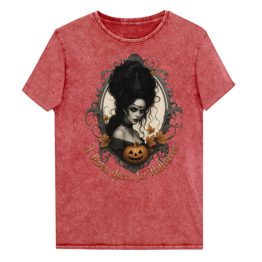 garnet red acid-wash unisex T-shirt featuring a gothic-style illustration of a dark-haired woman with an elaborate beehive hairstyle, framed by ornate scrollwork, autumn leaves, and a carved pumpkin. The design is captioned with the text ‘A Raven Queen for Halloween’ in vintage Dark Angle lettering. Branded RedBlonde in red on inside neck and right sleeve