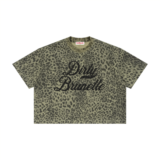green boxy T-shirt with an all-over animal print, contrasting ribbed crew neckline, and faded black Dirty Brunette Milkstore script graphic across the front.