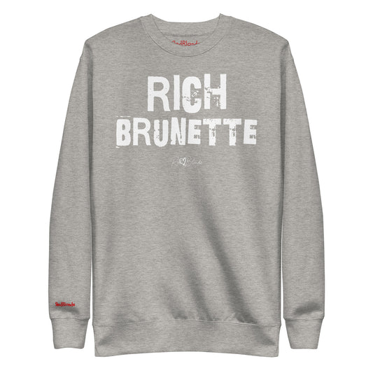 grey unisex premium sweatshirt with bold distressed white Ed Geinitext “RICH BRUNETTE” on the front, featuring a subtle RedBlonde logo beneath the lettering and on the sleeve cuff and inside neck
