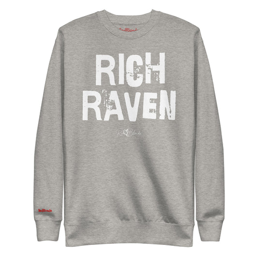 grey unisex premium sweatshirt with bold distressed white Ed Geinitext “RICH RAVEN” on the front, featuring a subtle RedBlonde logo beneath the lettering and on the sleeve cuff and inside neck
