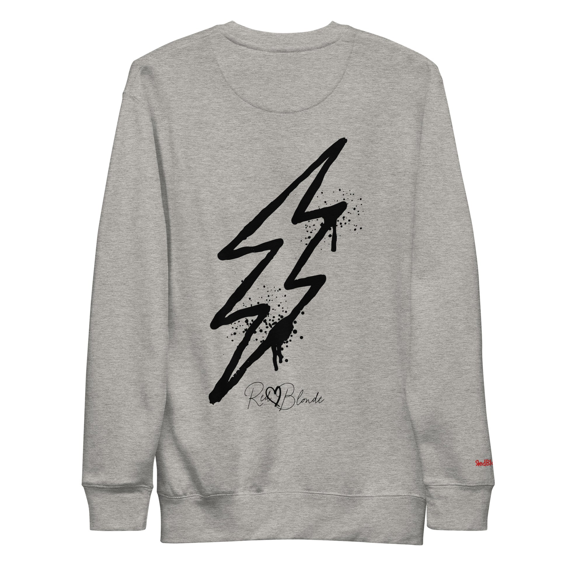 Back view of a grey unisex sweatshirt featuring a bold black lightning bolt graphic with paint-splatter detail and the RedBlonde logo printed below. The design has an edgy, electric streetwear vibe. Branded RedBlonde in red on right sleeve