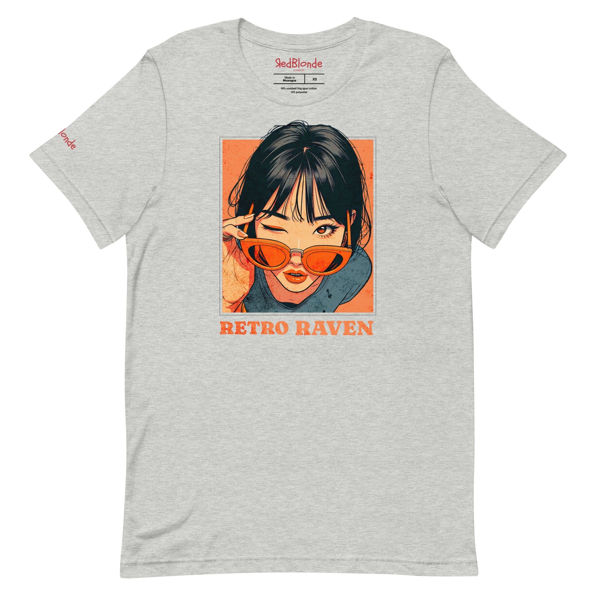 grey unisex t-shirt featuring a vintage-style illustrated graphic of a woman with black hair winking while lowering orange sunglasses. The design is framed in warm retro tones with the words “RETRO RAVEN” printed below in bold orange text. The RedBlonde logo appears inside the neckline and subtly on the sleeve.