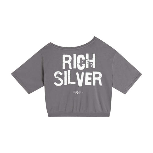 grey asymmetrical shoulder t-shirt with bold white Ed Gein font “RICH SILVER" slogan on the front and RedBlonde logo beneath.