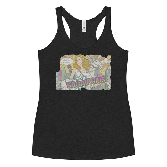 Flatlay of a heather black soft racerback tank t-shirt with a retro pop-art blonde Sagittarius graphic featuring a blonde woman, with bow & arrows, white stallion, and a city backdrop, captioned ‘Just a Sagittarius, armed with a bow & dreams'