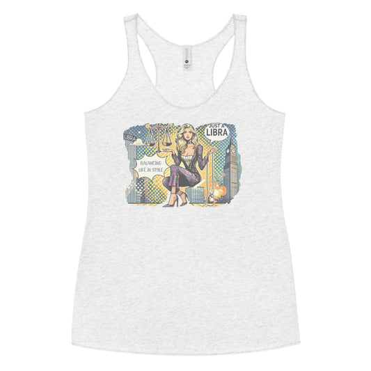 Flatlay of a heather white soft racerback tank t-shirt with a retro pop-art Libra graphic featuring a blonde woman, scales, and a city backdrop, captioned ‘Just a Libra, Balancing Life in Style’.