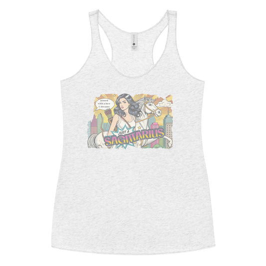 Flatlay of a heather white soft racerback tank t-shirt with a retro pop-art Sagittarius graphic featuring a black haired woman, with bow & arrows, white stallion, and a city backdrop, captioned ‘Just a Sagittarius, armed with a bow & dreams'