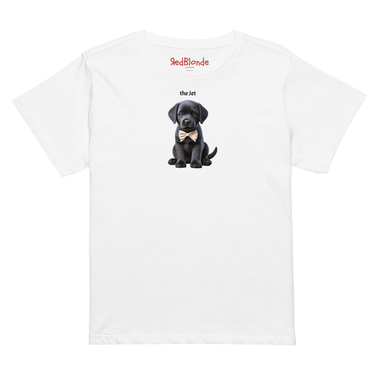 Flatlay of high waisted relaxed white t-shirt with cute graphic of jet black puppy wearing a bow-tie and the words 'the Jet' linking to black hair. It's branded Redblonde on the inside neck mockup