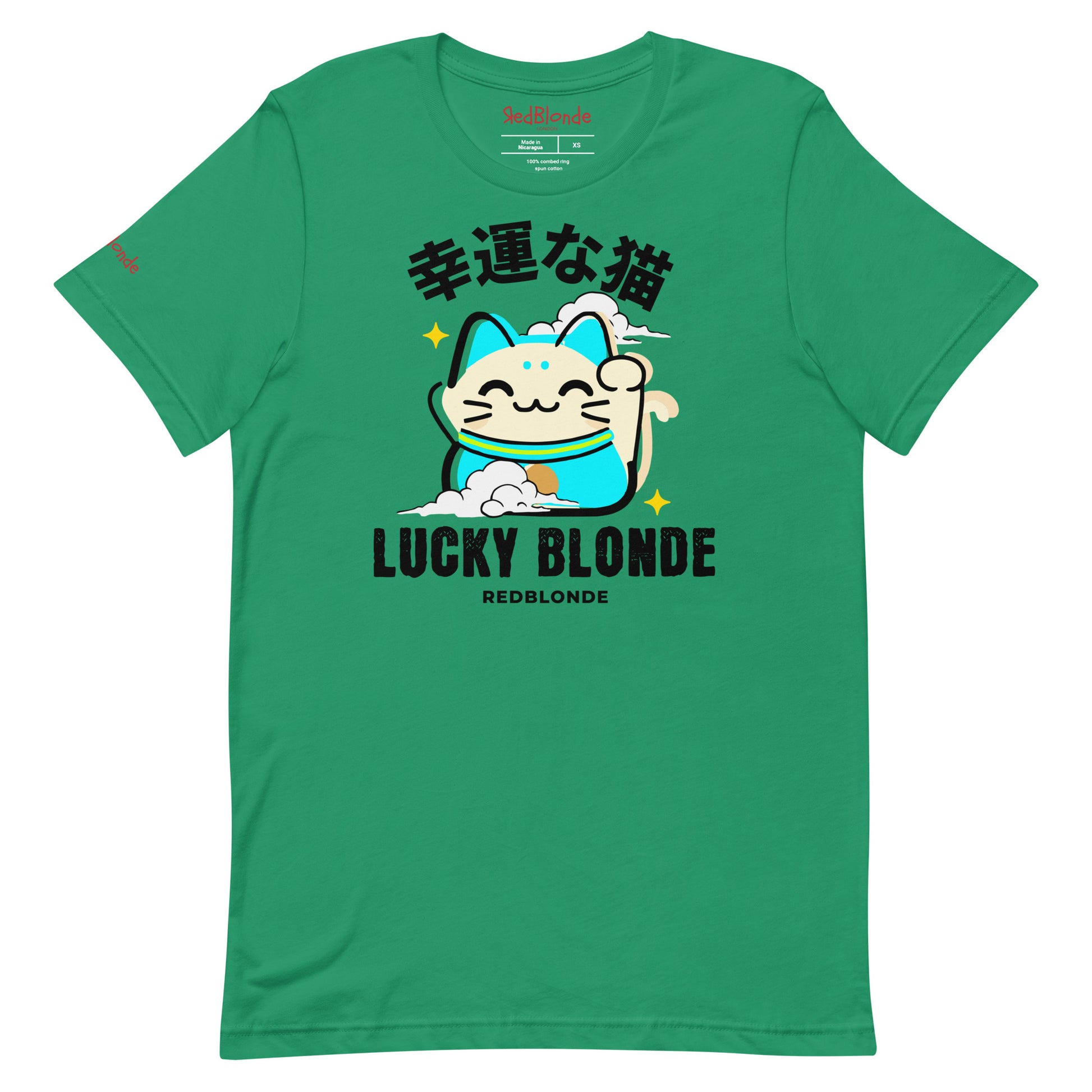 A kelly green unisex T-shirt featuring a cheerful maneki-neko (lucky cat) graphic in cream, turquoise, and black, with golden star accents. Above the cat are Japanese characters meaning “Lucky Cat.” Below the design, the text reads “LUCKY BLONDE” in bold black letters and “REDBLONDE” in smaller font. The T-shirt has a classic crew neckline and short sleeves. Branded RedBlonde on the inside neck and right sleeve