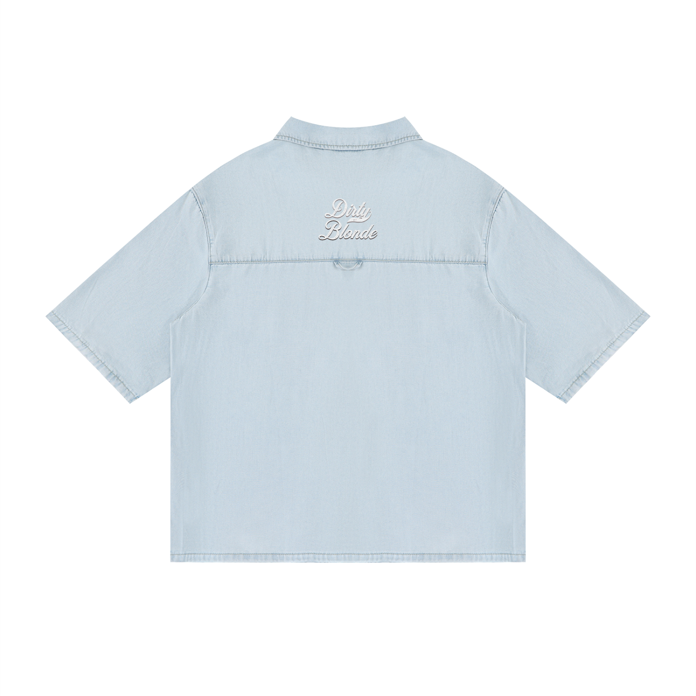 back view of a light blue, short-sleeve button-up shirt with a subtle faded finish and a small raised “Dirty Blonde” Milkstore script logo centered across the upper back.
