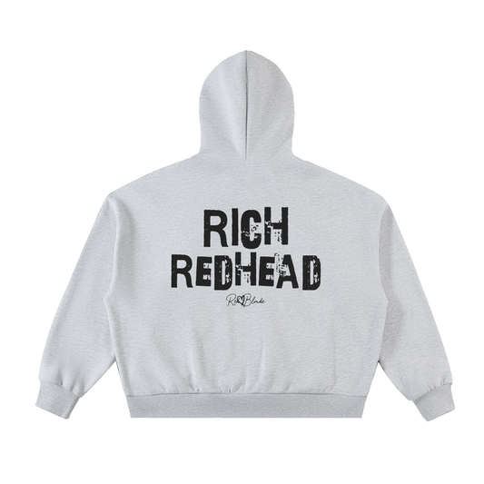 light grey hem to hood zip-up hoodie with cropped oversized fit and ribbed cuffs/hem, featuring large distressed black “RICH REDHEAD” Ed Gein text across the back with a small “RedBlonde” script logo beneath.