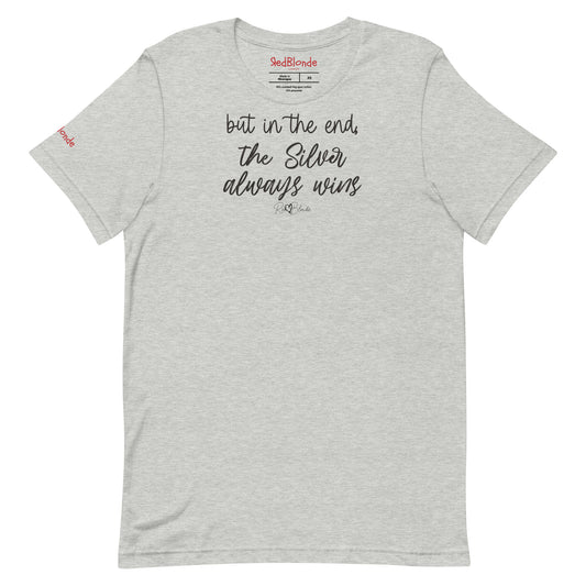 A light grey unisex t-shirt featuring the handwritten-style slogan “but in the end, the Silver always wins” in Hillbear font  in dark gray text across the chest, signed off RedBlonde. Branded “RedBlonde London on inside the collar and on the right sleeve