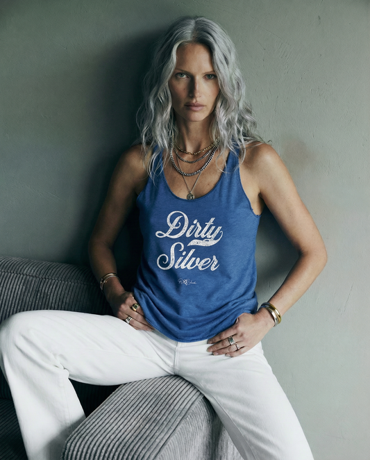 Model wears a blue women's racerback tank with the playful slogan ‘Dirty Silver’ in white milk-store font, signed off RedBlonde.