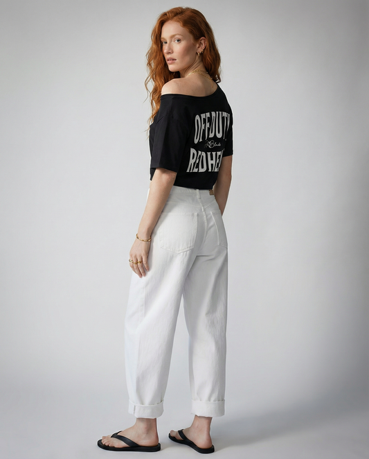 model wears black asymmetrical boxy T-shirt with white ‘OFF DUTY REDHEAD’  brookfield text back print and RedBlonde signature logo.”