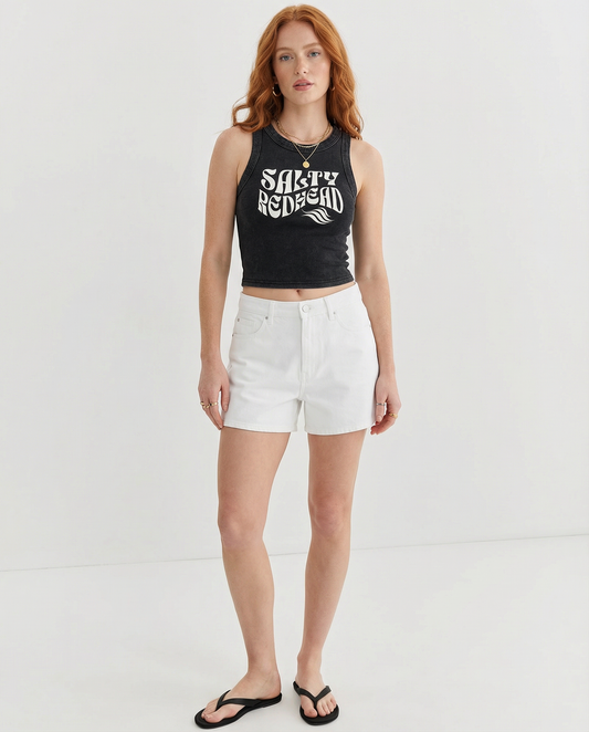 Models wears black sleeveless crop tank top with a high neckline, featuring a white Solino Display retro-style “Salty Redhead” font graphic across the chest 