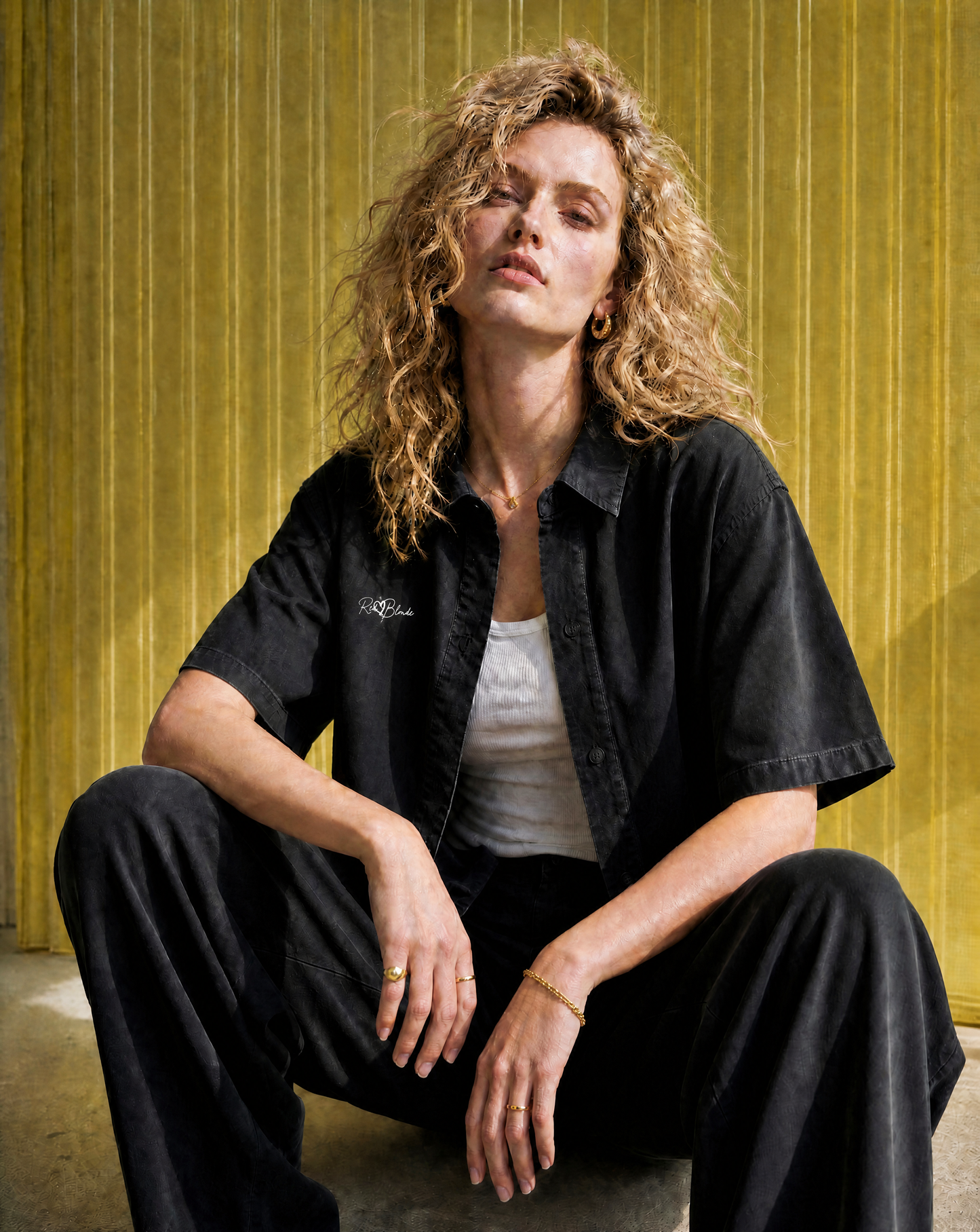 Models wears a black lyocell short sleeved shirt with RedBlonde signature style logo on right chest