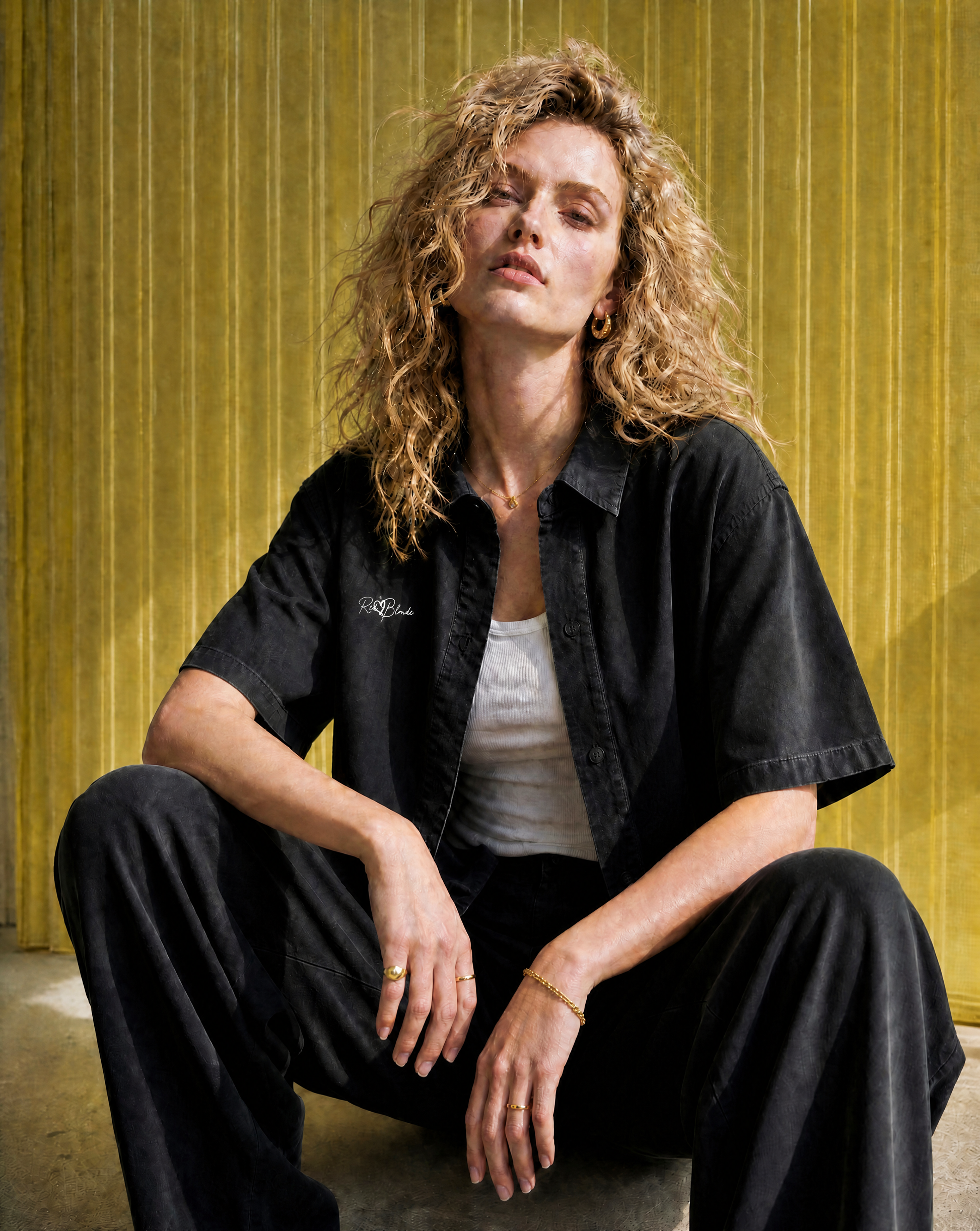 Models wears a black lyocell short sleeved shirt with RedBlonde signature style logo on right chest