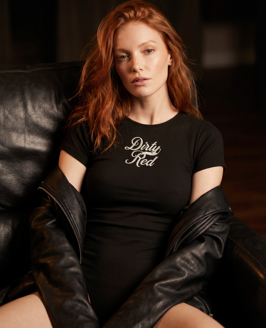 Model wears a Washed charcoal ribbed short sleeve bodysuit with a crew neckline and white Dirty Red Milkstore font graphic at the chest.