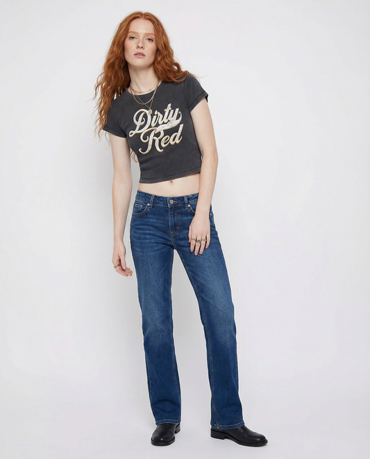 model wears a black short-sleeve crop T-shirt with large cursive “Dirty Red” Milkstore text in white and yellow on the front
