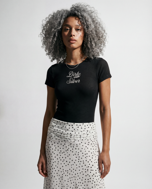 model wears Washed charcoal ribbed short sleeve bodysuit with a crew neckline and white Dirty Silver Milkstore font graphic at the chest.
