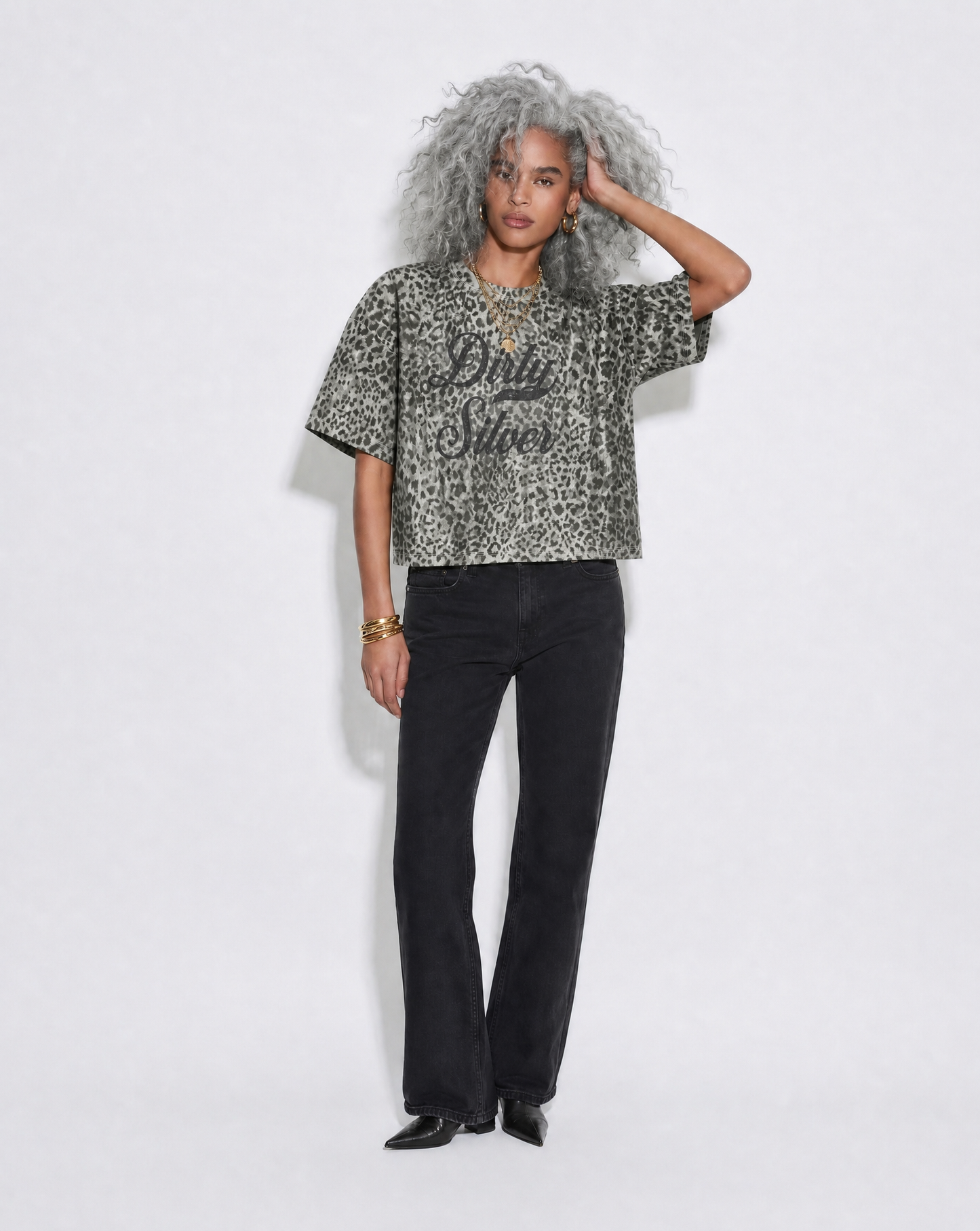 model wears grey boxy  T-shirt with an all-over animal print, contrasting ribbed crew neckline, and faded black Dirty Silver Milkstore script graphic across the front.