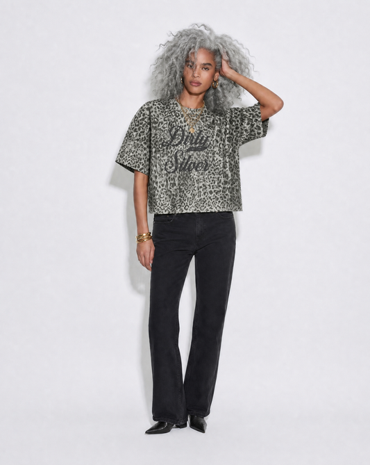model wears grey boxy  T-shirt with an all-over animal print, contrasting ribbed crew neckline, and faded black Dirty Silver Milkstore script graphic across the front.