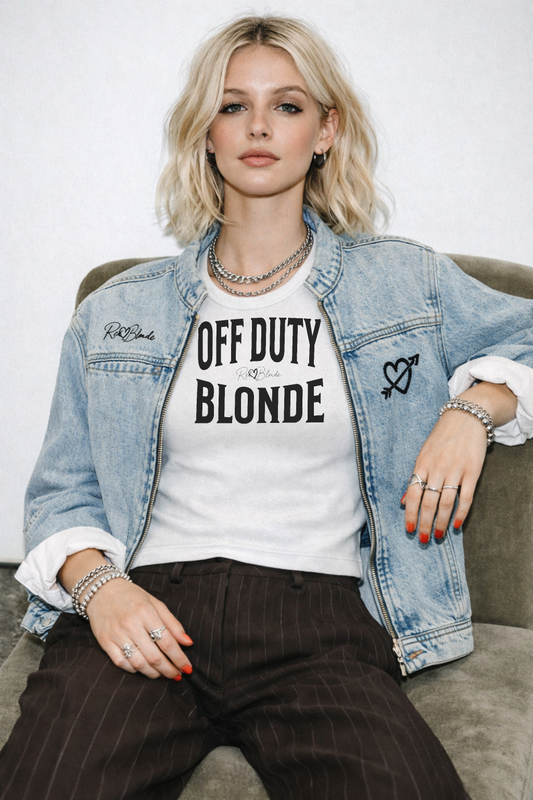 model wears a white sleeveless vintag acid wash tank top laid flat on a white background, with black text on the chest reading “OFF DUTY BLONDE” in bold Brookfield lettering, and a small cursive RedBlonde signature logo between the words. 
