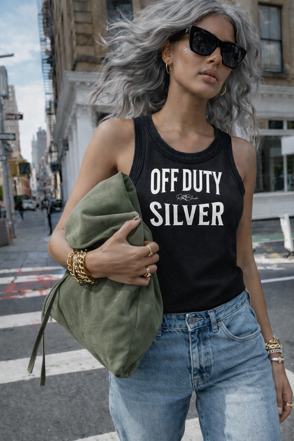 A black sleeveless vintage acid wash tank top laid flat on a white background, with white text on the chest reading “OFF DUTY SILVER” in bold Brookfield lettering, and a small cursive RedBlonde signature logo between the words. 