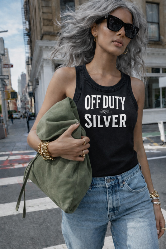 A black sleeveless vintage acid wash tank top laid flat on a white background, with white text on the chest reading “OFF DUTY SILVER” in bold Brookfield lettering, and a small cursive RedBlonde signature logo between the words. 