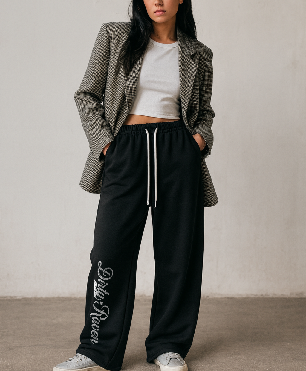 model wears a Black relaxed-fit straight joggers with white drawstrings and vintage-style “Dirty Raven” milkstore script printed vertically down the leg — bold, effortless and unmistakably RedBlonde.