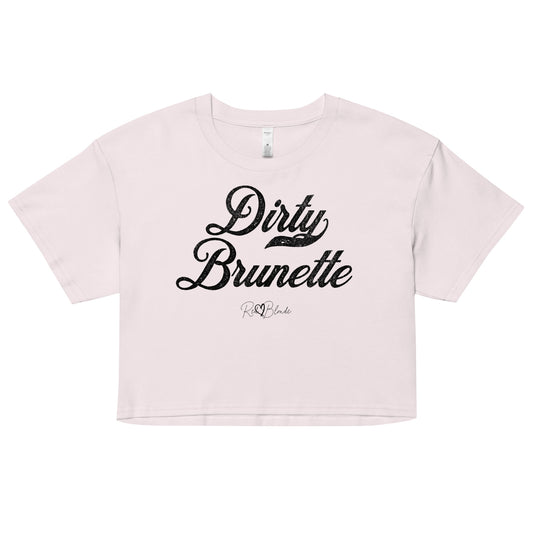 Orchid women’s crop top featuring the phrase “Dirty Brunette” in bold, black milkstore vintage-style script across the chest. Below the phrase, the brand name “RedBlonde” is printed in a smaller, elegant handwritten font.
