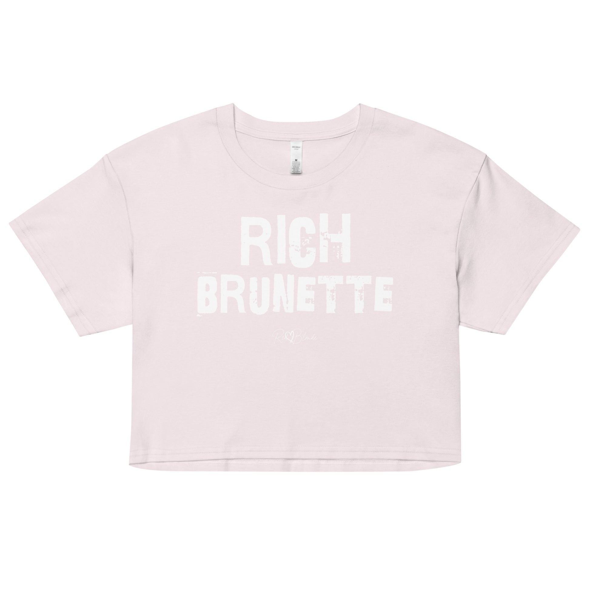 orchid crop top with a relaxed fit, short sleeves, and a wide crew neckline. The front features bold black distressed Ed Gein lettering reading “RICH BRUNETTE” with the RedBlonde signature logo underneath in black