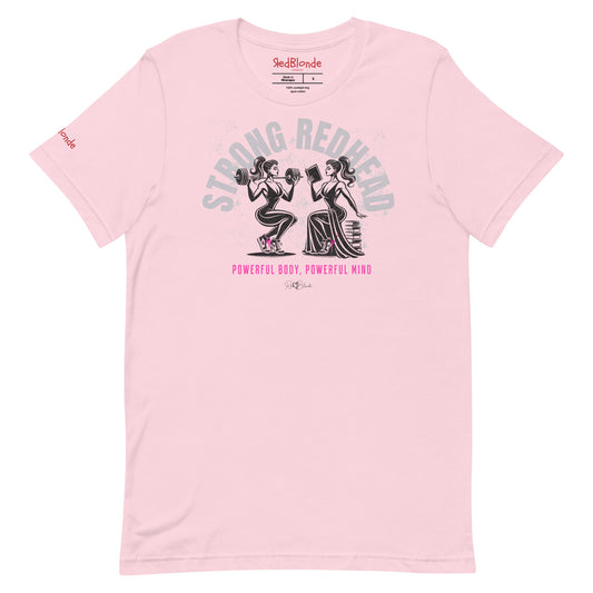 A pale pink relaxed-fit crew neck t-shirt featuring a graphic of two women: one holding a barbell on her shoulders, the other reading a book on a pile of books. The words ‘STRONG REDHEAD’ are arced over the women in pale grey, while ‘Powerful Body, Powerful Mind’ is in bright pink underneath. The t-shirt is signed off RedBlonde with a heart. Branded RedBlonde in red on inside neck and right sleeve