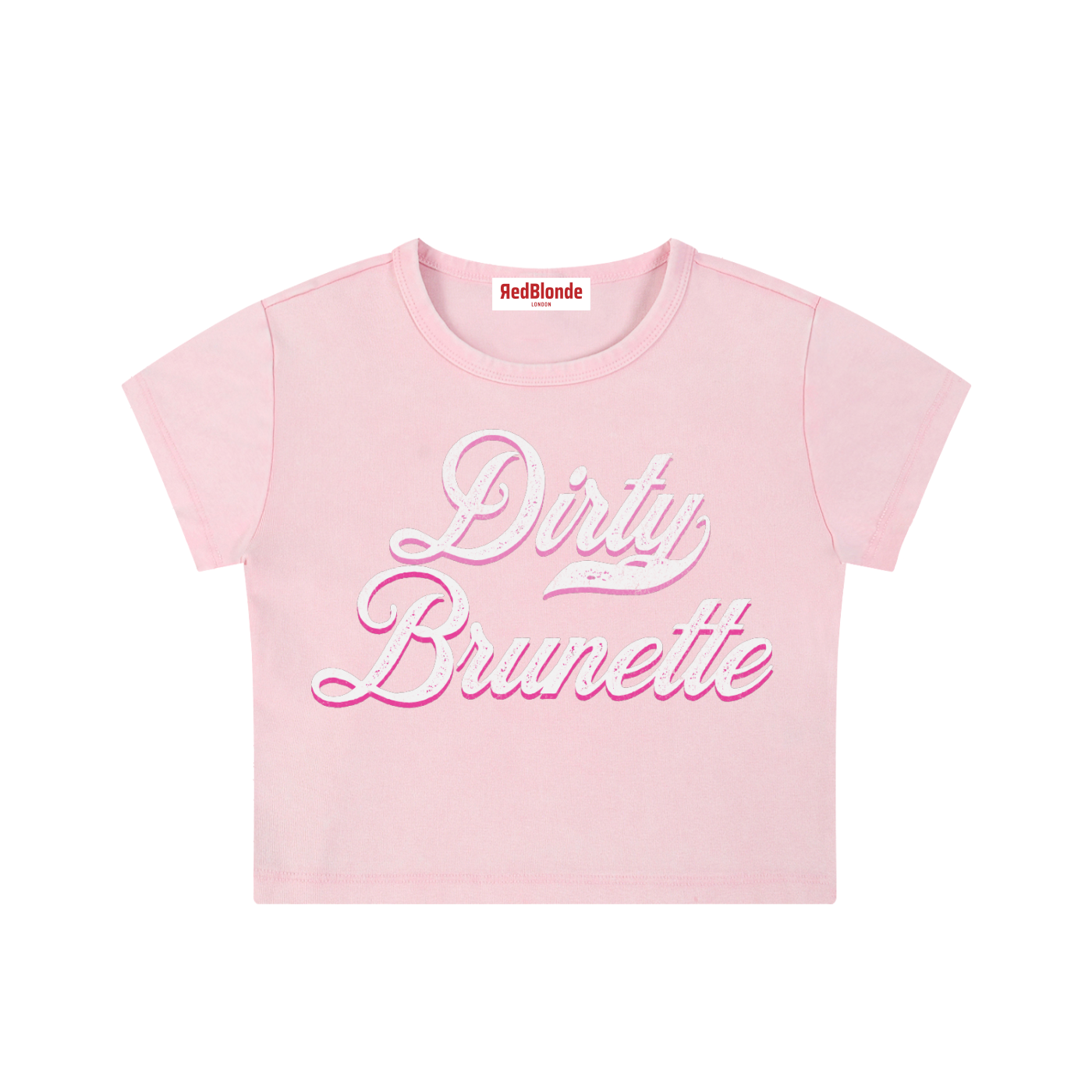 Light pink short-sleeve crop T-shirt with large cursive “Dirty Brunette” Milkstore text in white and pink on the front, and a small “RedBlonde London” label at the neckline.