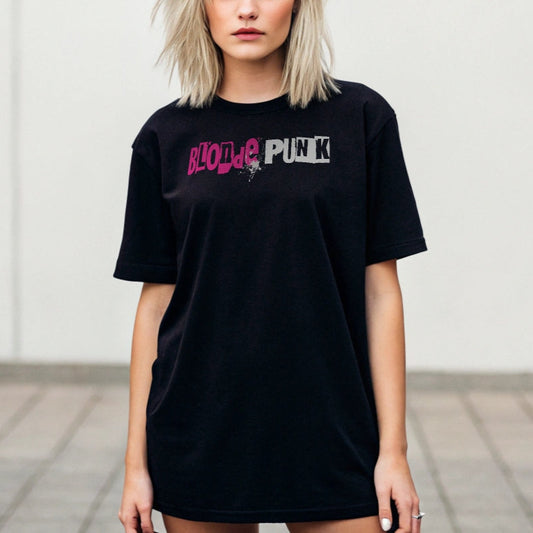 punky blonde wears a black relaxed fit graphic t-shirt with 'Blonde Punk' in irregular printing block style caps and lowercase. Blonde is written in bright prink and Punk in white lettering. Branded RedBlonde London in inside neck and right sleeve