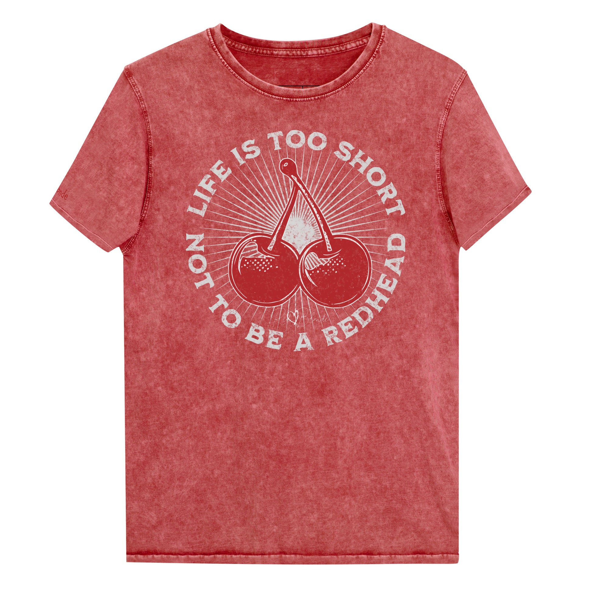 red garnet acid-wash unisex T-shirt featuring a bold red cherry graphic in the center. Surrounding text reads “Life is too short not to be a redhead” in distressed white adventure font lettering. The inside neck and sleeve also feature the RedBlonde logo in red.