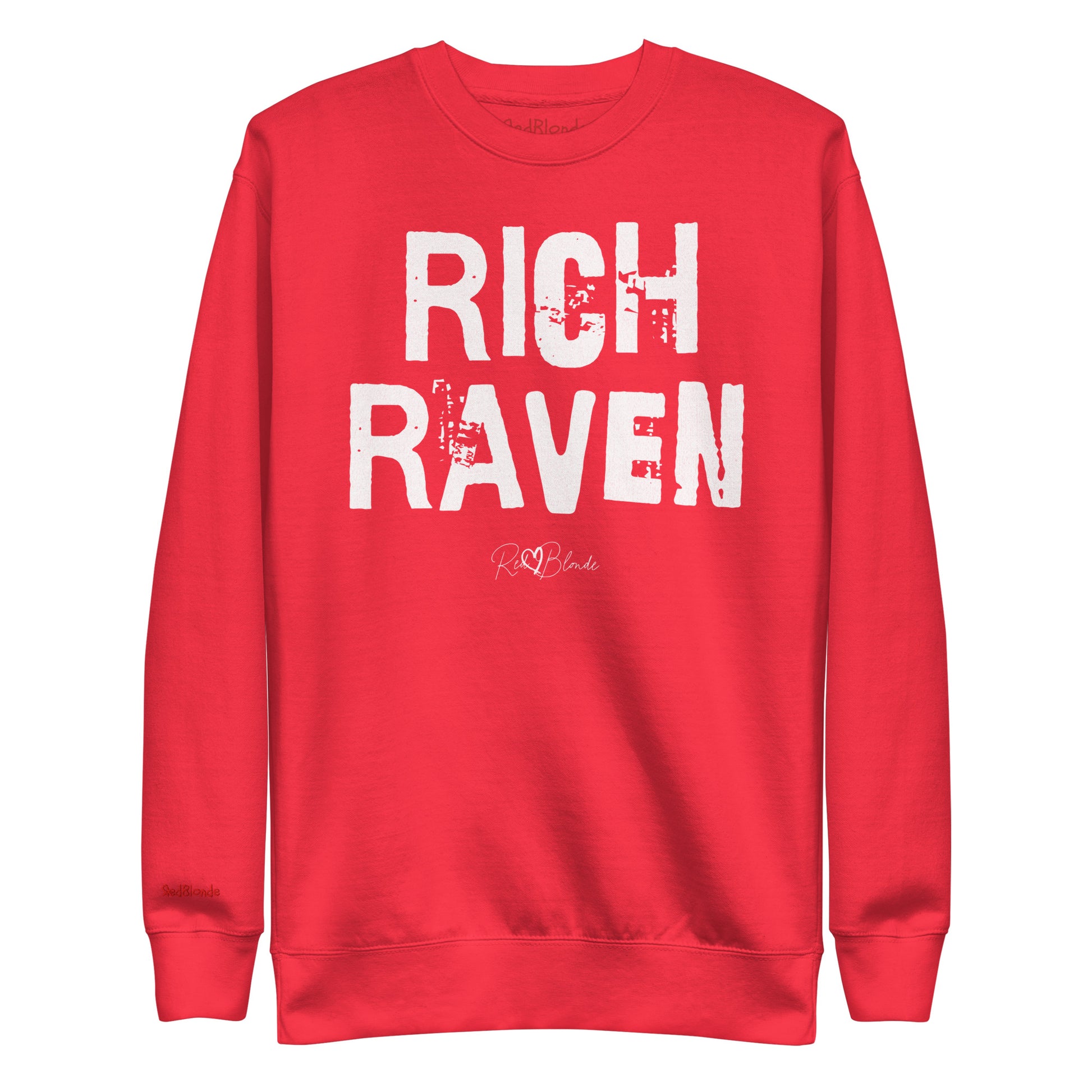 red unisex premium sweatshirt with bold distressed white Ed Geinitext “RICH RAVEN” on the front, featuring a subtle RedBlonde logo beneath the lettering and on the sleeve cuff and inside neck