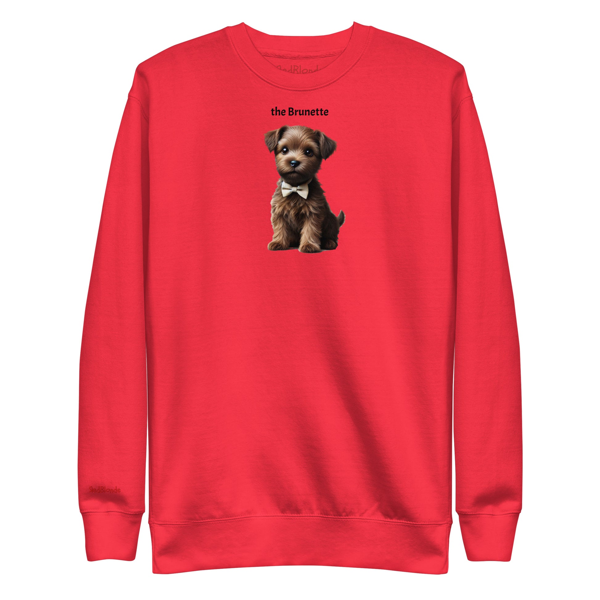 Flatlay of red relaxed fit unisex sweatshirt with a cute graphic of a Brunette puppy wearing a bow-tie and the words 'the Brunette' linking to Brunette hair. Branded RedBlonde in red on inside neck and right cuff