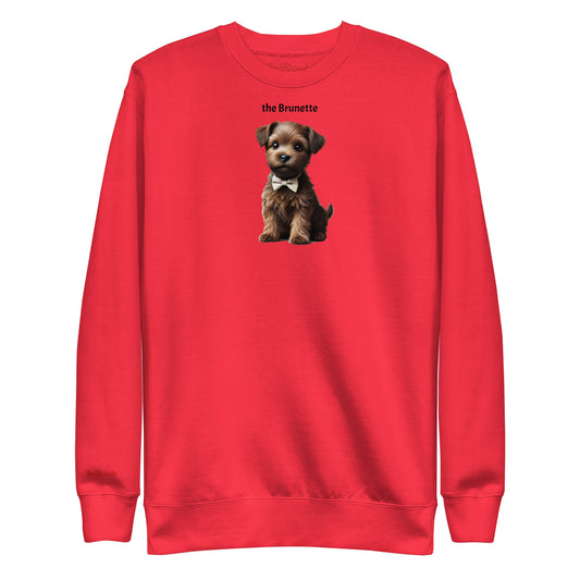 Flatlay of red relaxed fit unisex sweatshirt with a cute graphic of a Brunette puppy wearing a bow-tie and the words 'the Brunette' linking to Brunette hair. Branded RedBlonde in red on inside neck and right cuff