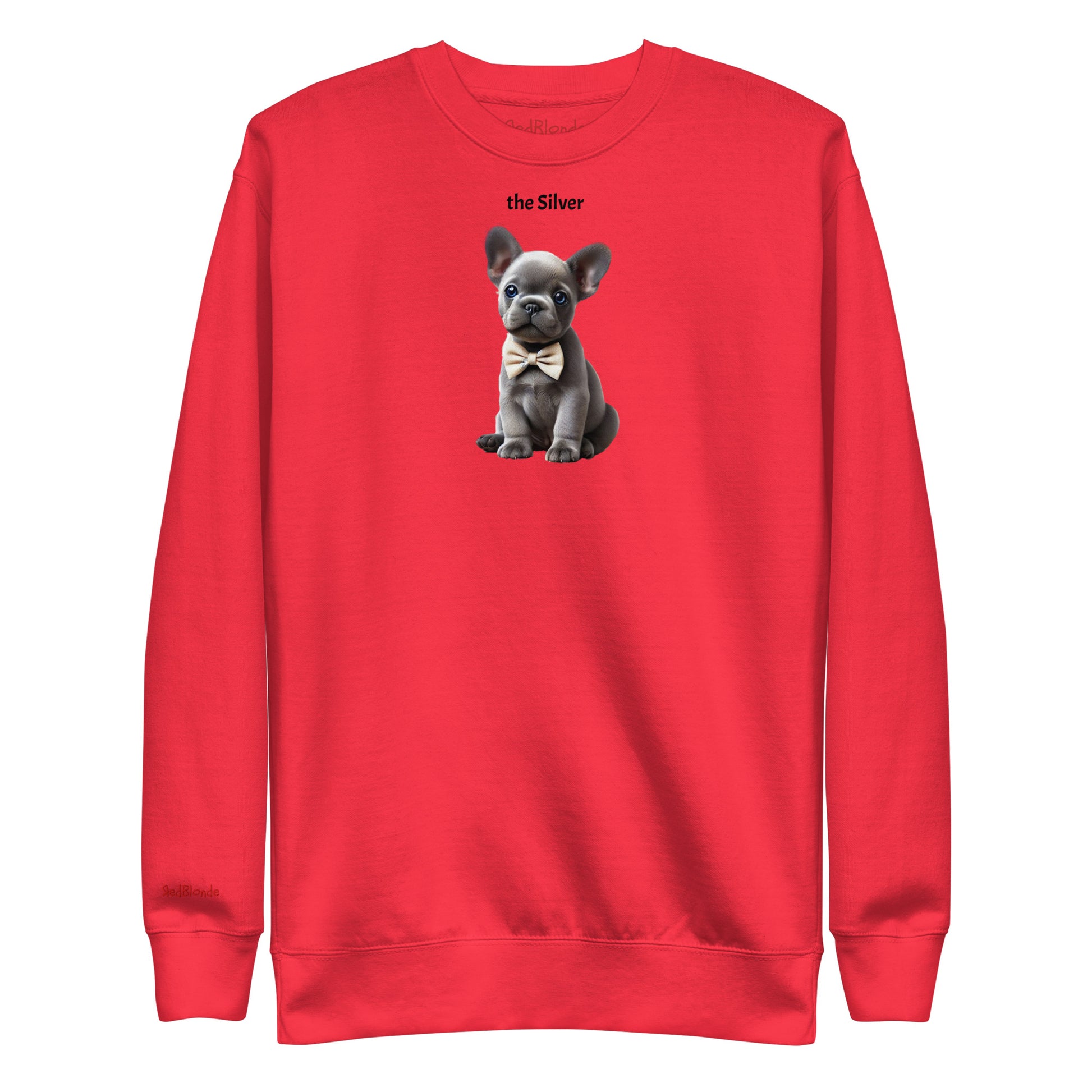 Flatlay of red relaxed fit unisex sweatshirt with a cute graphic of a Silver puppy wearing a bow-tie and the words 'the Silver' linking to silver hair. Branded RedBlonde in red on inside neck and right cuff