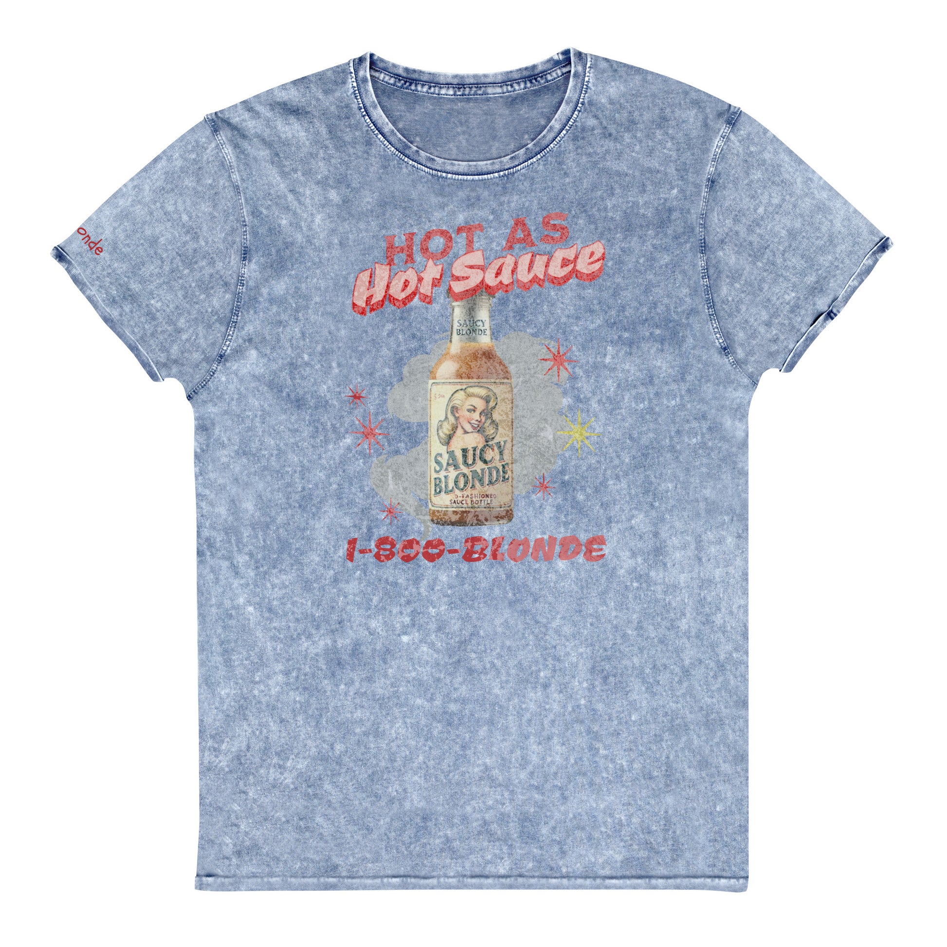 flatlay of a relaxed blue denim-wash t-shirt with a retro American-vintage pop-art graphic featuring a bottle of sauce with Saucy Blonde on it and the words Hot As hot Sauce. branded with redblonde london in red on the inside neck and right shoulder