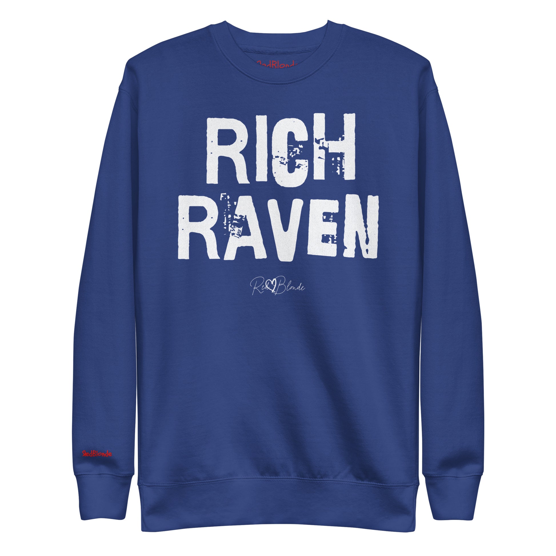 Royal Blue unisex premium sweatshirt with bold distressed white Ed Geinitext “RICH RAVEN” on the front, featuring a subtle RedBlonde logo beneath the lettering and on the sleeve cuff and inside neck